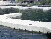 Dock sections on lake with cabin in background