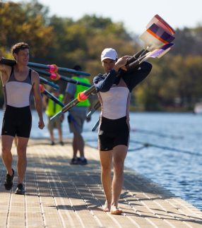 Rowing team walking on a floating dock walkway