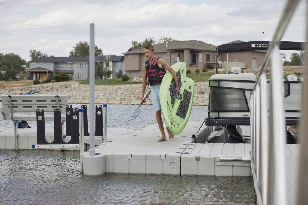 Man carrying paddle board