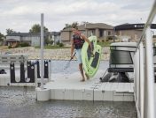 Man carrying paddle board