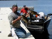 Man holding fish on a dock