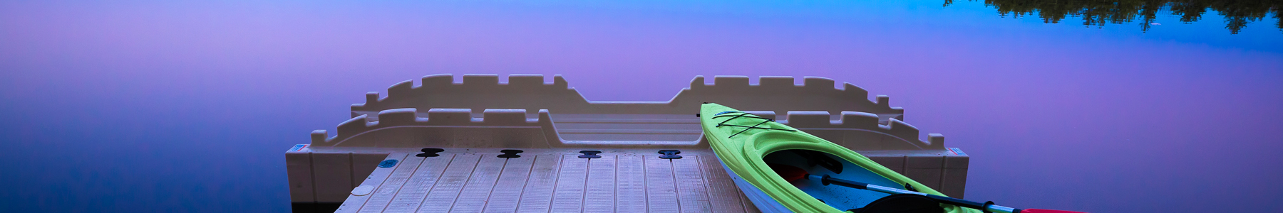 Kayak resting on dock with empty launch