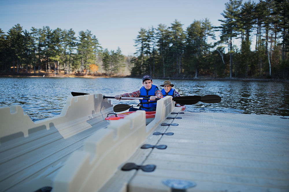 A father and son launch their kayak