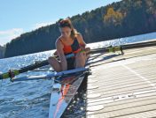 Woman about to go out on water in kayak