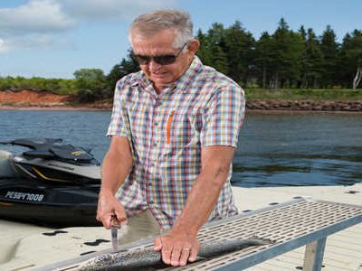 Man using fish cleaning station on dock