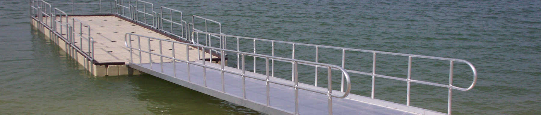 A metal gangway leads to a floating dock