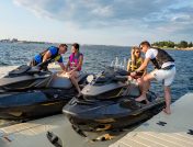Two couples mounting on 2 jet skis