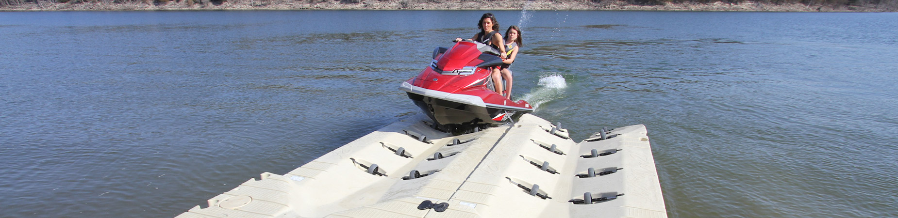 Girls on jet ski loading onto floating port