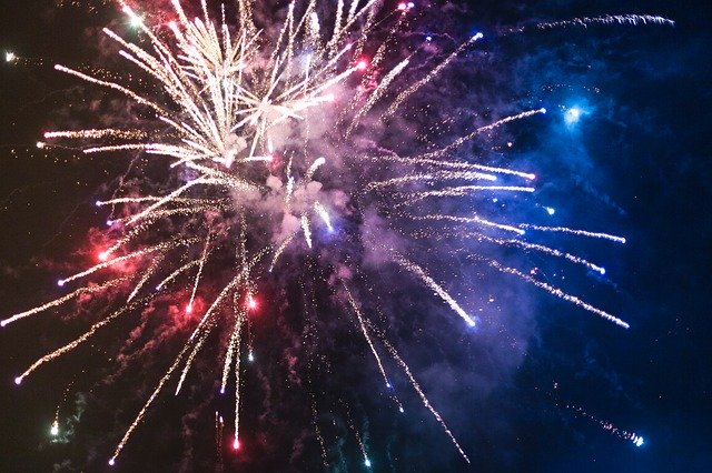 Fireworks display with red, white, blue, and gold colors