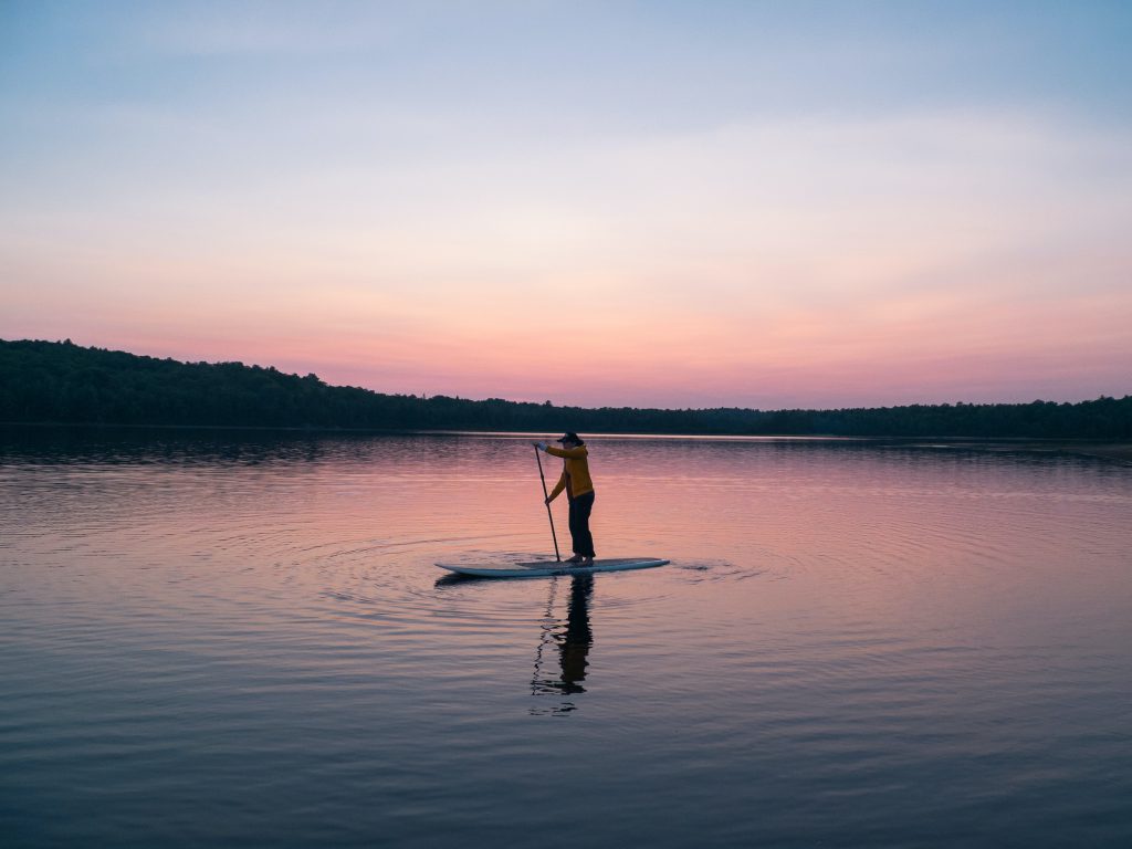 paddle boarding dusk