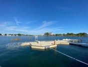 Floating dock with kayakers in background