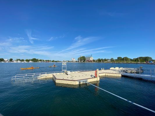 Floating dock with kayakers in background