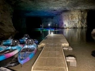 Spelunkers paddleboarding in cave