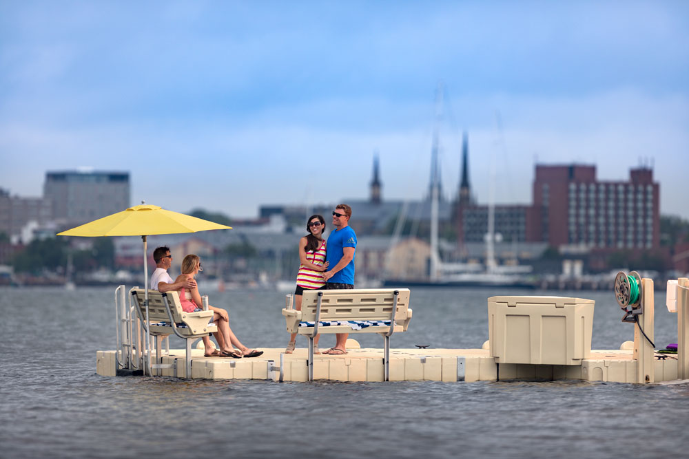 2 couples on floating dock across from city