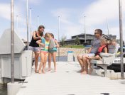 Children playing on the dock with parents