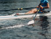 Man rowing with paddles moving in water